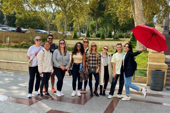 Guide leading travelers through historic courtyards of Baku’s UNESCO Old City.